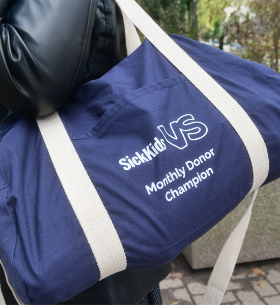 Bag with Monthly Donor Champion written on it