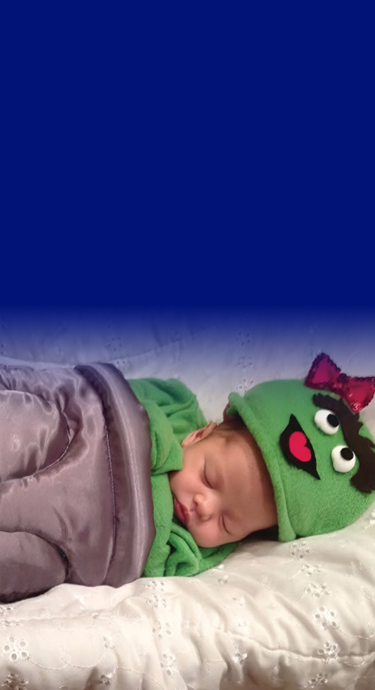Baby Rian sleeping and dressed up as Oscar the grouch.