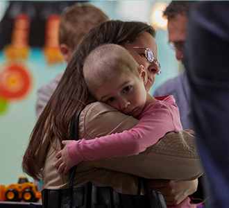 Mother hugging daughter