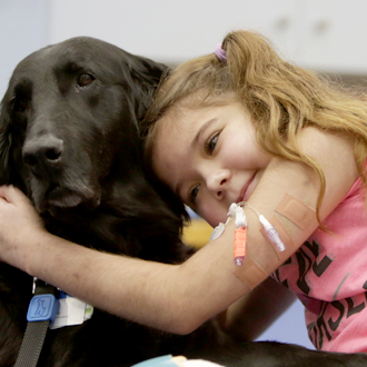 SickKids patient hugging dog