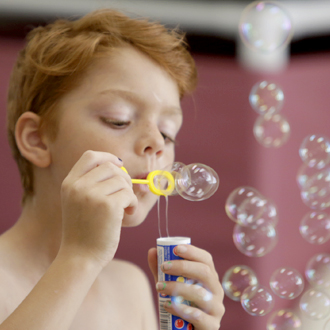SickKids patient blowing bubbles
