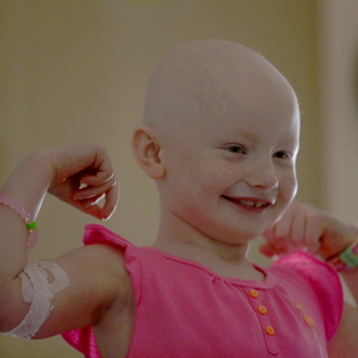 Bald SickKids patient showing arm muscles